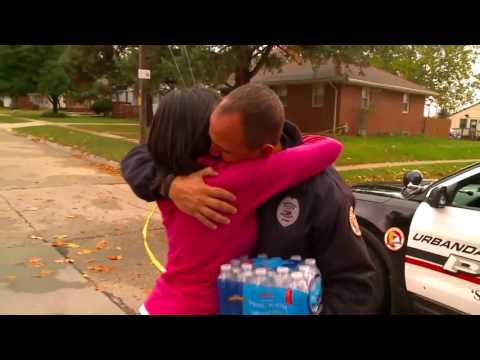 Tearful hugs as woman brings water to Urbandale officer