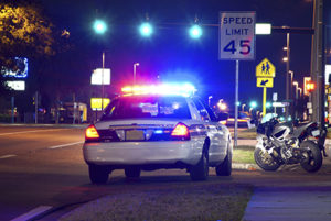 Motorcycle pulled over after a pursuit at night